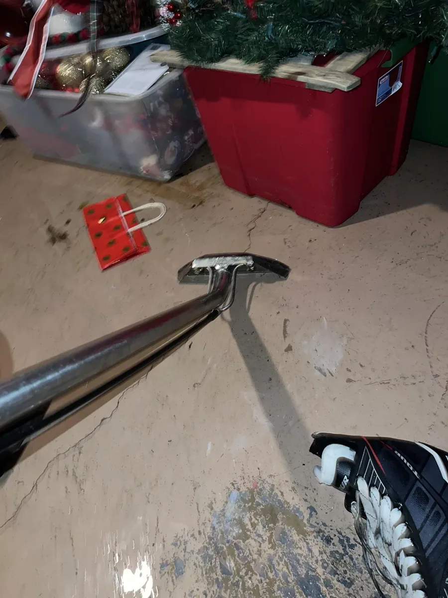 Extraction wand removing standing water beside stored items in a Huntingdon Valley basement