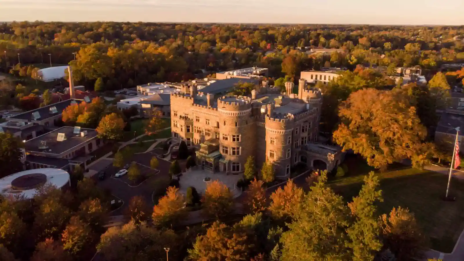 Aerial view of a large stone building surrounded by trees.